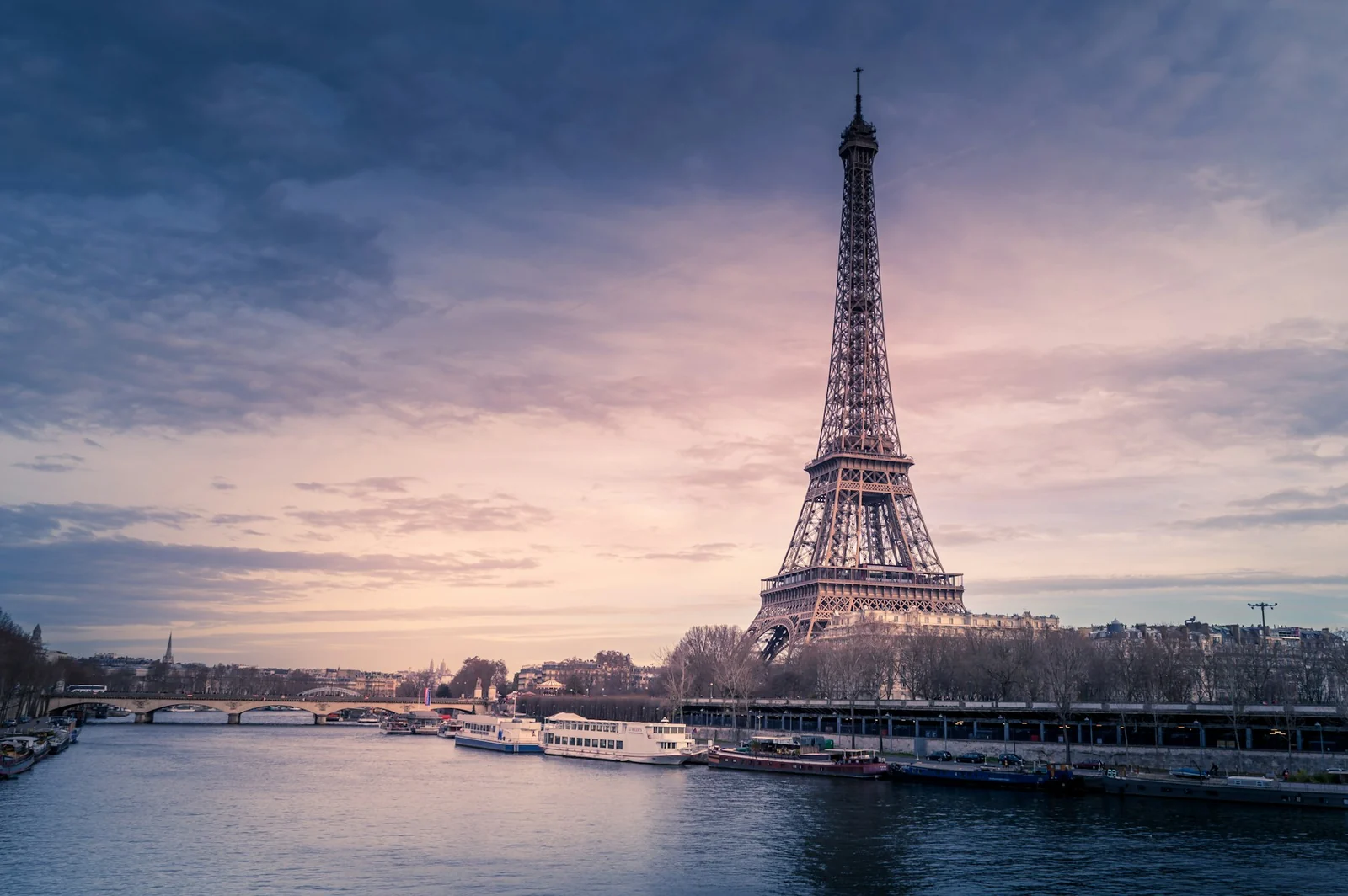 The Eiffel Tower beside the Seine at sunset in Paris, France